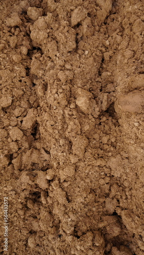 Closeup of macro view of red dirt or mud of pile soil from agriculture land. Soil Background.