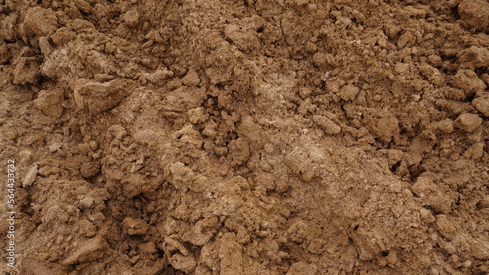 Closeup of macro view of red dirt or mud of pile soil from agriculture land. Soil Background.