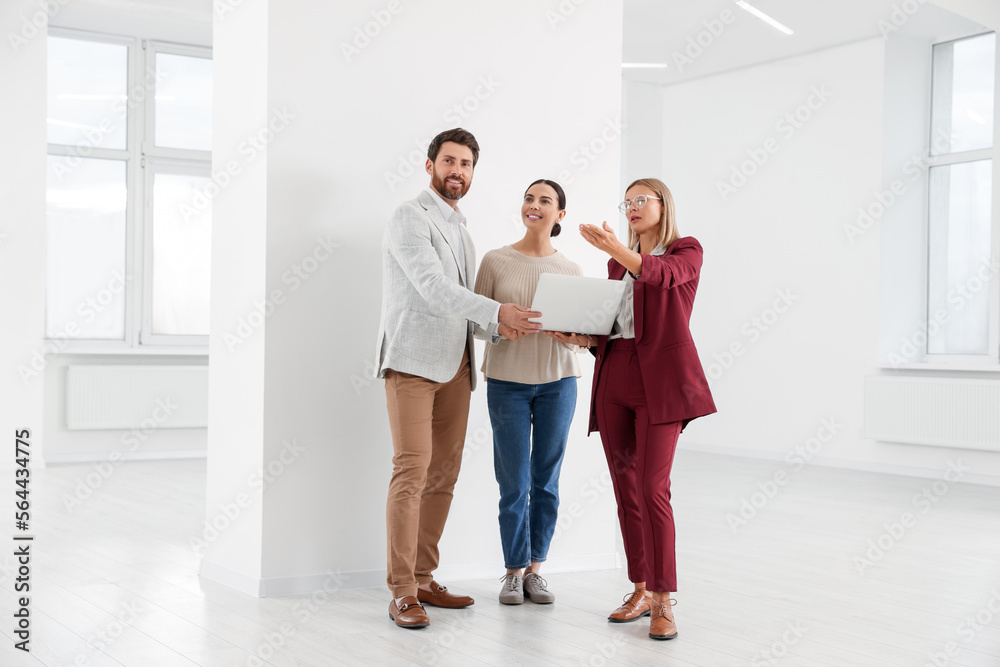 Real estate agent showing new apartment to couple Real estate agent showing new apartment to couple