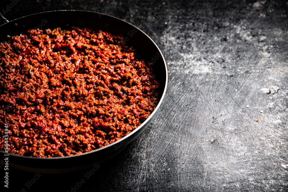 Delicious bolognese sauce in a frying pan. Delicious bolognese sauce in a frying pan.