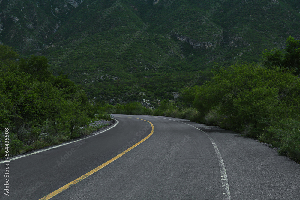 Beautiful view of empty asphalt highway near mountains outdoors. Road trip Beautiful view of empty asphalt highway near mountains outdoors. Road trip
