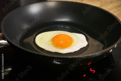 Cooking egg for tasty breakfast in frying pan