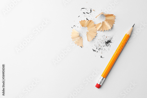 Fotografie Graphite pencil and shavings on white background, flat lay