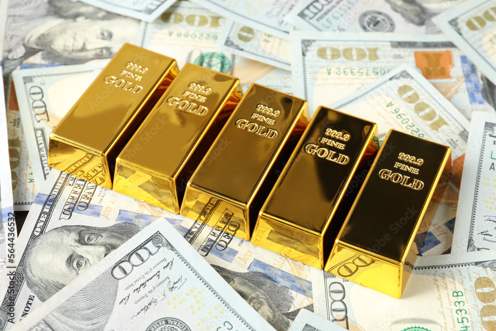Many shiny gold bars on dollar banknotes Many shiny gold bars on dollar banknotes