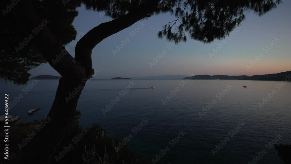 Sailboat and Aegean Sea near the Old Town of Skiathos at dusk, Skiathos Town, Skiathos Island, Sporades Islands, Greek Islands Sailboat and Aegean Sea near the Old Town of Skiathos at dusk, Skiathos Town, Skiathos Island, Sporades Islands, Greek Islands