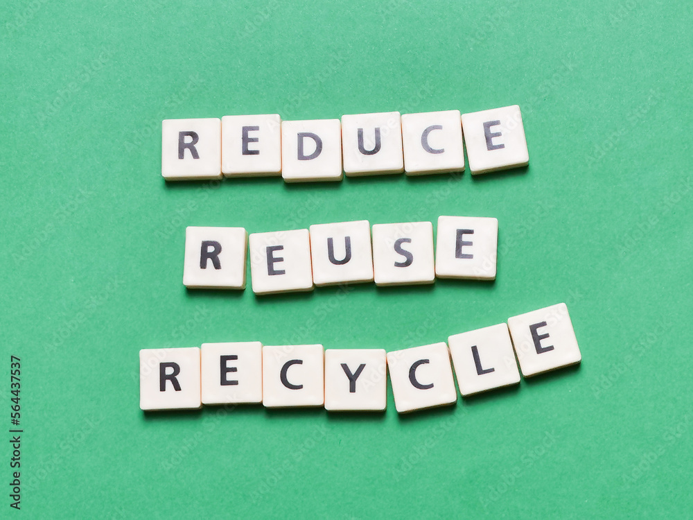 Reduce reuse and recycle made of square letter tiles against green ...