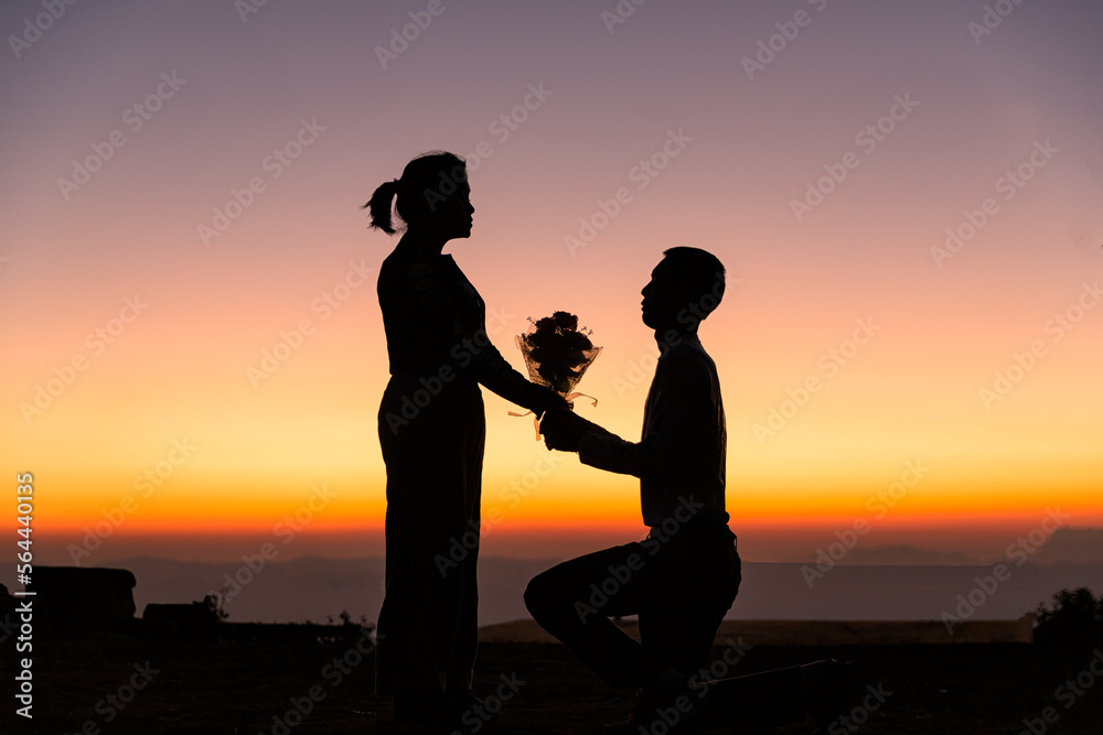 Silhouette of wedding Couple in love during sunrise with morning sky background. Pre-wedding portraits happy couple images man and woman with sky nature background. valentines day concept.