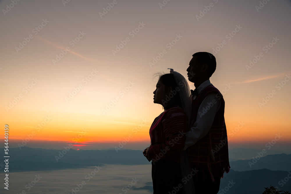 Silhouette of wedding Couple in love during sunrise with morning sky background. Pre-wedding portraits happy couple images man and woman with sky nature background.