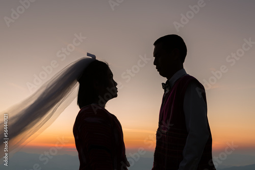 Silhouette of wedding Couple in love during sunrise with morning sky background. Pre-wedding portraits happy couple images man and woman with sky nature background.