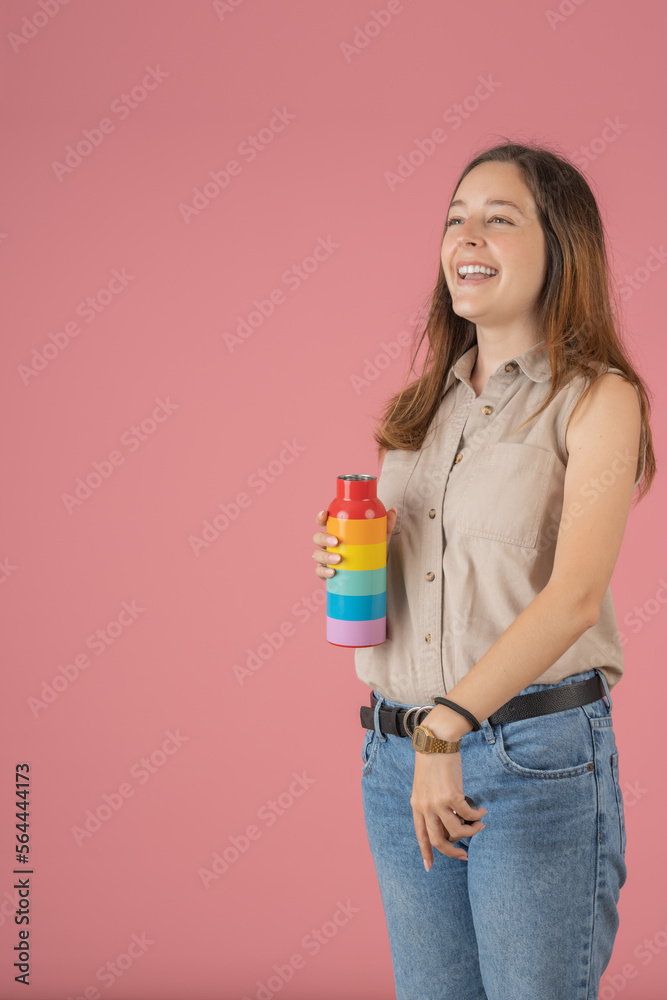 Young woman laughing with her rainbow bottle Young woman laughing with her rainbow bottle