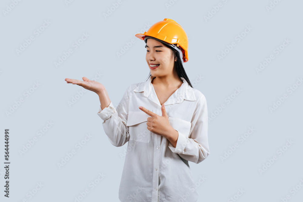 Young asian engineer female standing with open palm posture Young asian engineer female standing with open palm posture