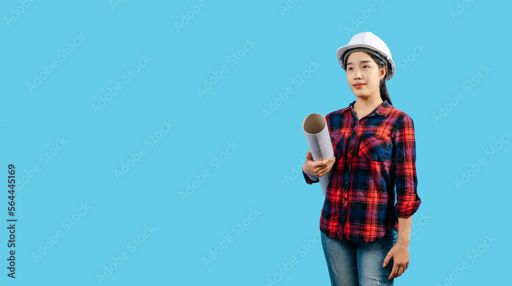 Young female engineer wearing white safety helmet with Blueprints Young female engineer wearing white safety helmet with Blueprints