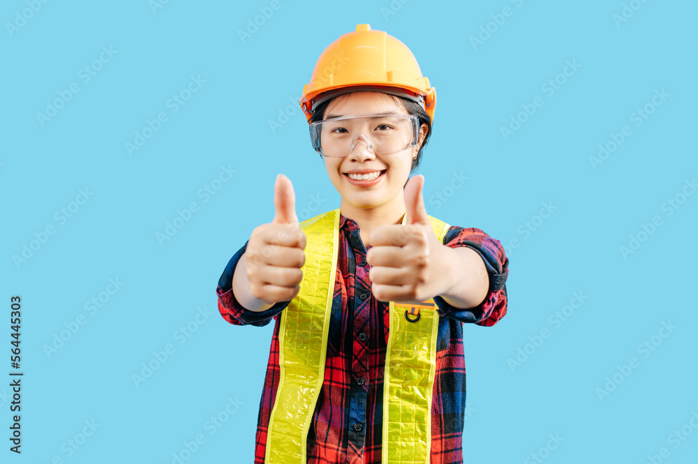 Young female engineer wearing yellow helmet show hand sign posture