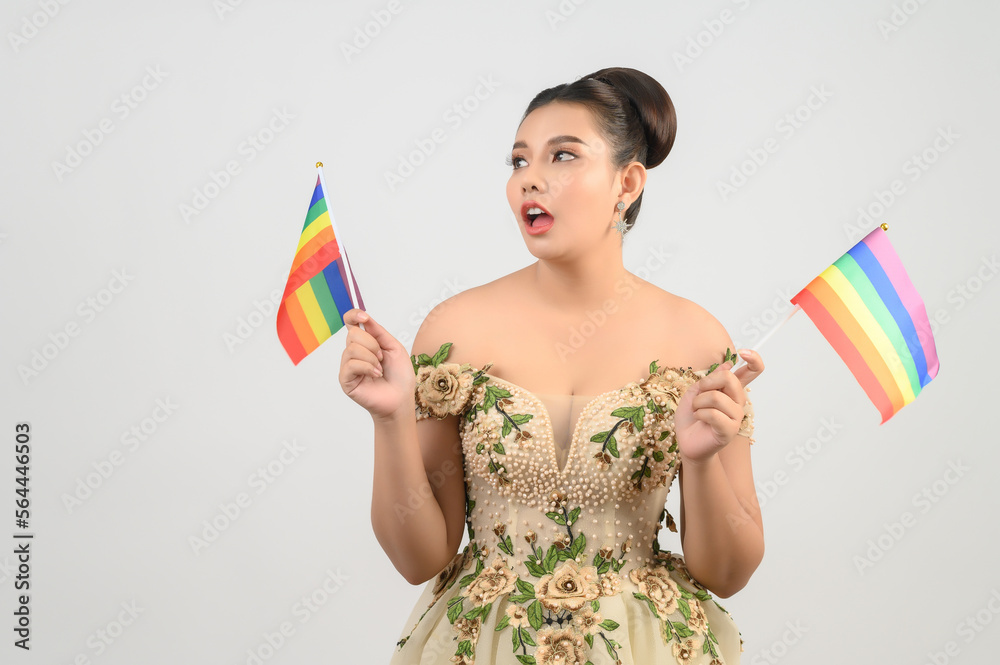 Young asian beautiful bride with rainbow flag on white background Young asian beautiful bride with rainbow flag on white background