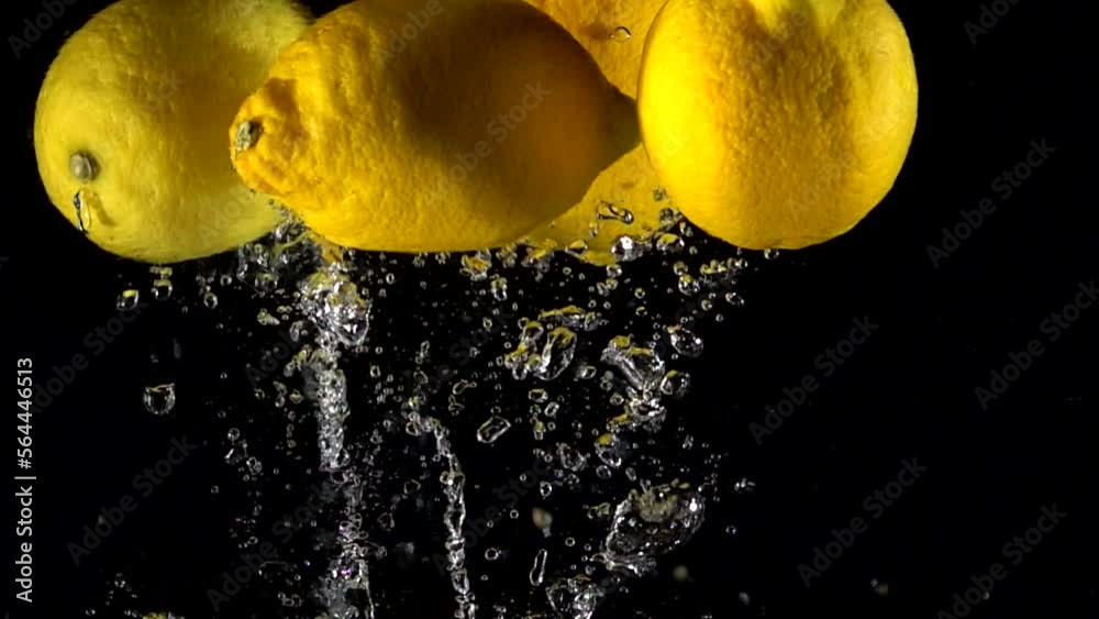Super slow motion of falling lemon into splashing water. Lemonade cooking concept. Filmed on high speed cinema camera, 4k 1000 fps.