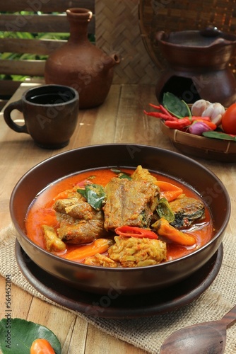 fish stew and spicy tofu dish on cup and teapot background