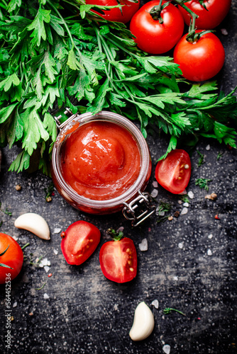 Tomato sauce in a glass jar with parsley and garlic. 