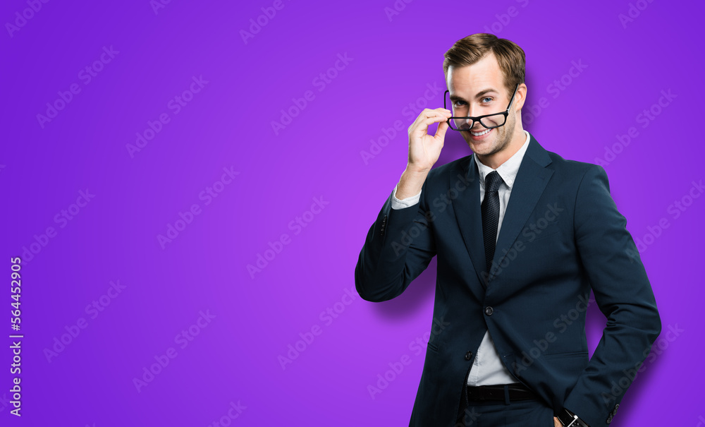 Portrait of businessman in black confident suit looking throw eye glasses, spectacles, on violet purple background. Smiling business man at studio ad concept. Copy space. Portrait of businessman in black confident suit looking throw eye glasses, spectacles, on violet purple background. Smiling business man at studio ad concept. Copy space.