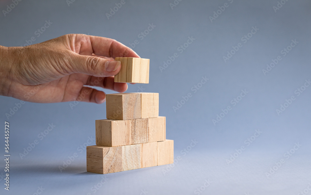 Hand stacking wood blocks. Business growth or team work concept, copy space. Hand stacking wood blocks. Business growth or team work concept, copy space.