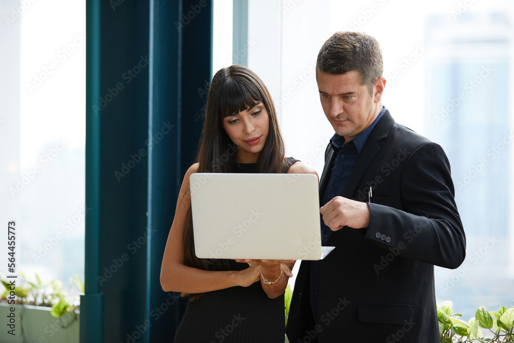 businesswoman and businessman working with laptop computer in the office
