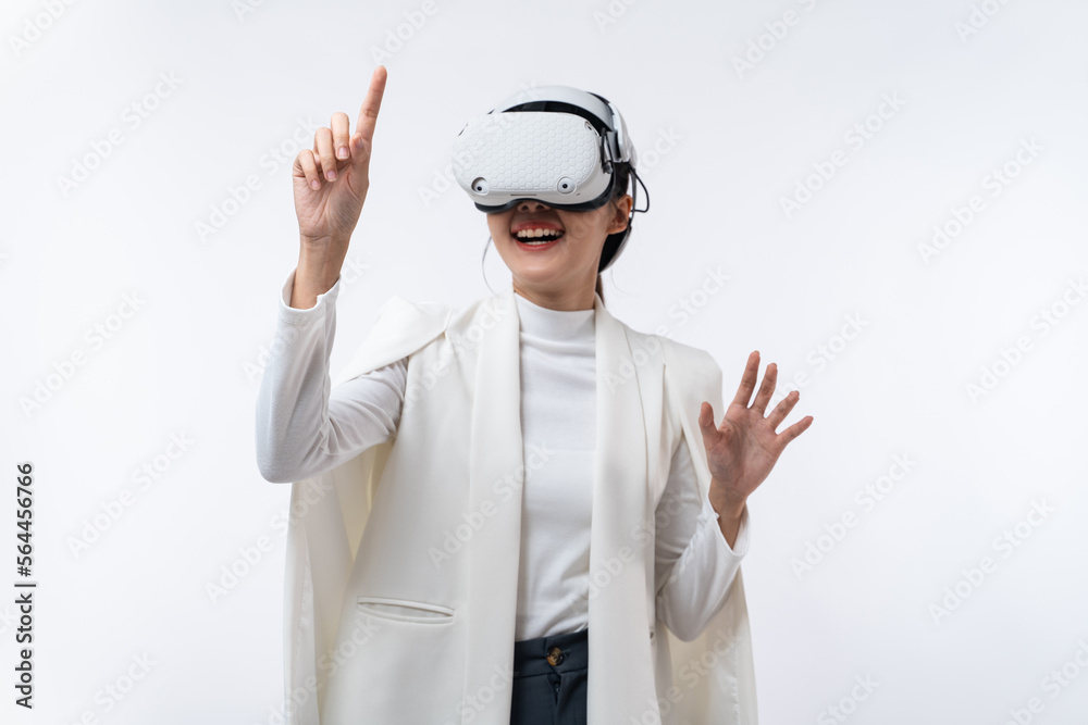 Happy young Asian businesswoman working in virtual reality environment in VR glasses touching virtual interface isolated on white background. Happy young Asian businesswoman working in virtual reality environment in VR glasses touching virtual interface isolated on white background.
