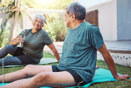 Yoga, fitness and senior couple in garden with exercise, cardio and workout together on grass for retirement health. Water bottle, nutrition and healthy elderly people or friends in backyard pilates