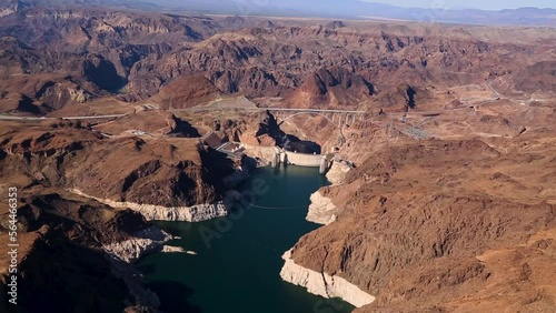 Aerial of the Hoover Dam, a major tourist attraction in the USA. The dam on the Colorado river impounds Lake Mead, Four-lane Hoover Dam Bypass It includes a steel and concrete arch bridge.