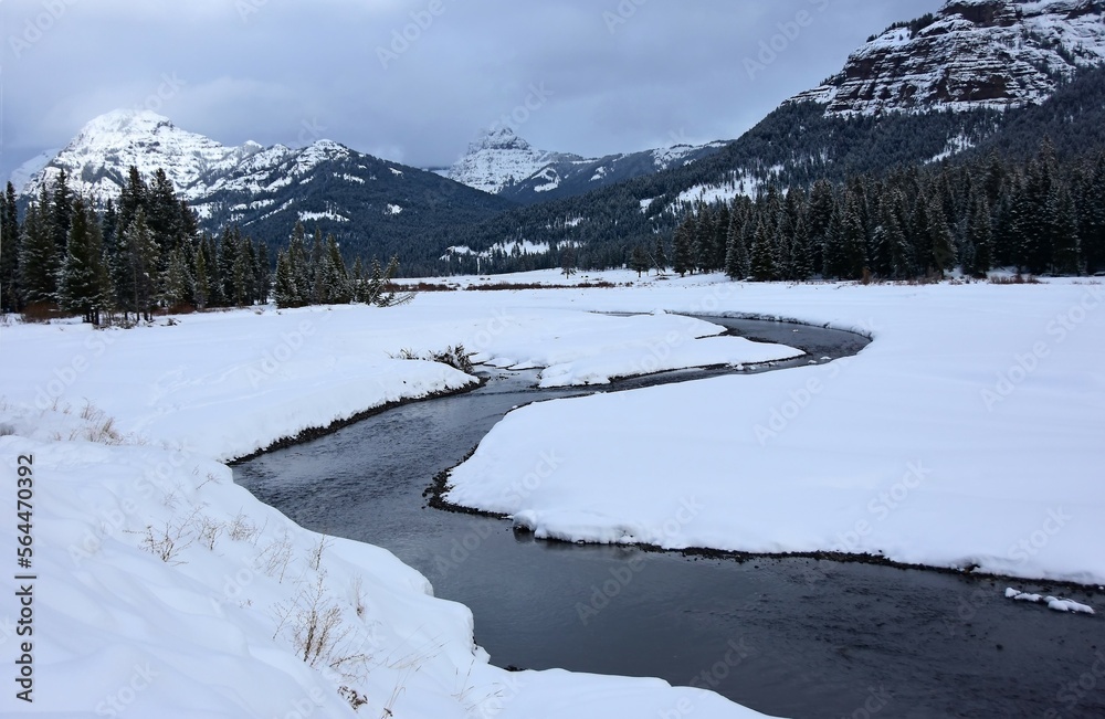picturesque snowy mountain  and lamar river  scene along the grand loop road in winter in the lamar valley of northeastern yellowstone national park, wyoming