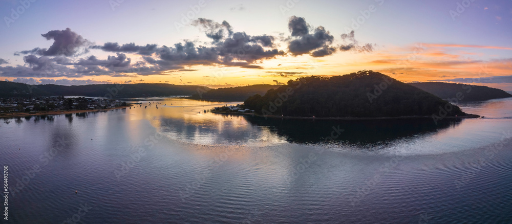 Fototapeta premium Aerial sunrise waterscape with boats and scattered clouds