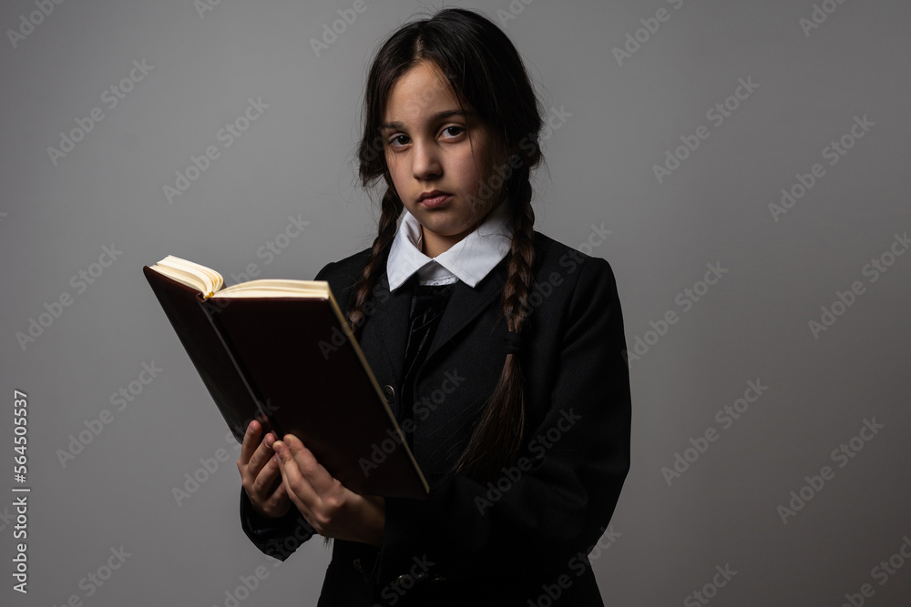 A girl with braids in a gothic style on a dark background. A girl with braids in a gothic style on a dark background.