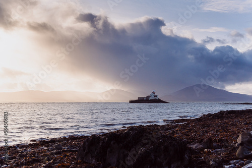 Aerial panorama view of the historic Fenit Lighthouse in Tralee Bay, beautiful clouds, sunset. High quality photo