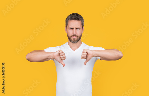photo of caucasian man wear white shirt thumb down. man wearing casual style. bearded man