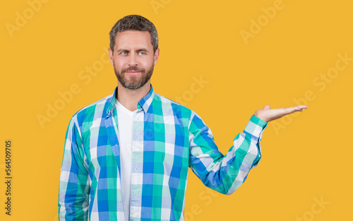 photo of caucasian guy wear checkered shirt presenting copy space. caucasian guy