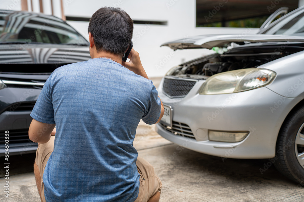 One man reporting car crash damage calling insurance and Claim roadside service One man reporting car crash damage calling insurance and Claim roadside service
