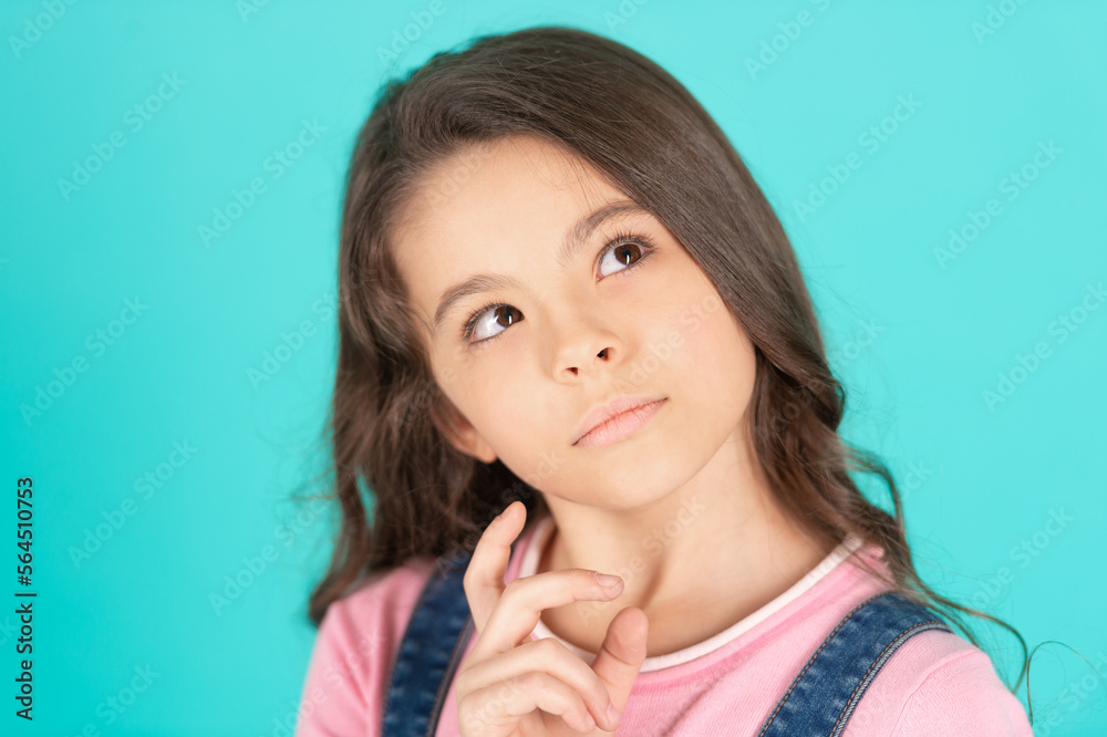 portrait of thoughtful teen girl isolated on blue. portrait of teen girl in studio. portrait of thoughtful teen girl isolated on blue. portrait of teen girl in studio.