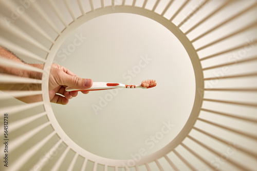 The toothbrush is thrown away for disposal and recycling in the trash. View from below. The concept of disposal and recycling of waste.