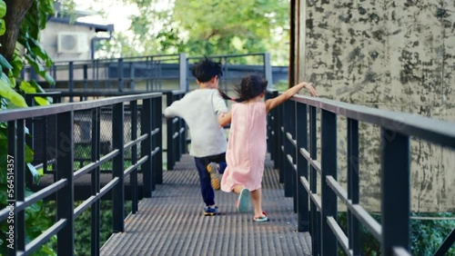 Wallpaper Mural 2 children Asian brothers and sisters Run hand in hand on outdoor playground. There's lot of fun, laughs, of both of them. Torontodigital.ca
