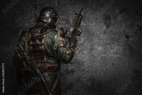 Shot of military man dressed in gas mask and ragged uniform with shotgun.
