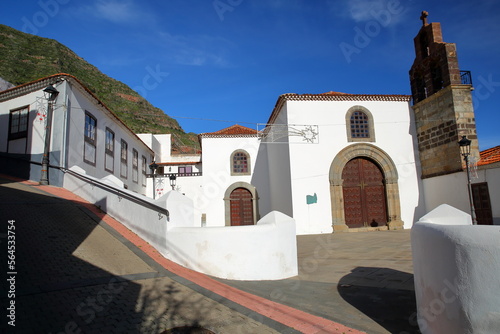 The monastic church of the Dominican monastery (El Convento de Santo Domingo) in Hermigua, La Gomera, Canary Islands, Spain, with cobbled streets and whitewashed houses photo