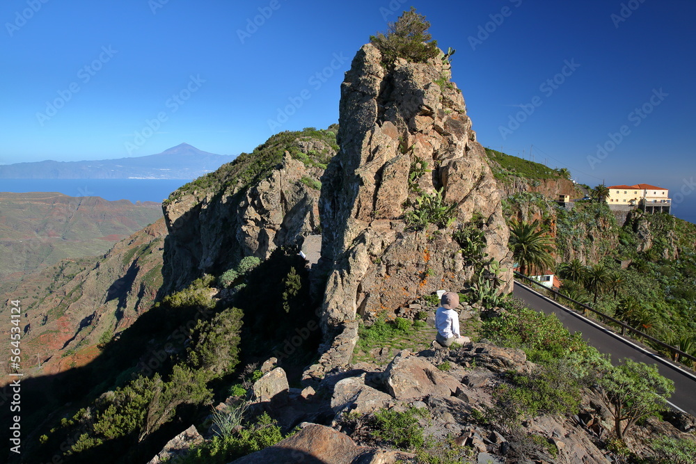 View of mountainous landscape and rock formations from the mirador (viewpoint) Degollada de Peraza, La Gomera, Canary Islands, Spain, towards el Teide Volcano (in Tenerife Island) 