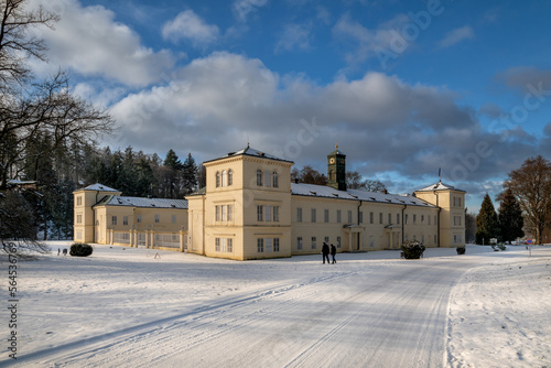 State Classicist chateau Kynzvart in winter under snow and with blue sky - castle is located near the famous west Bohemian spa town Marianske Lazne (Marienbad) - Czech Republic photo