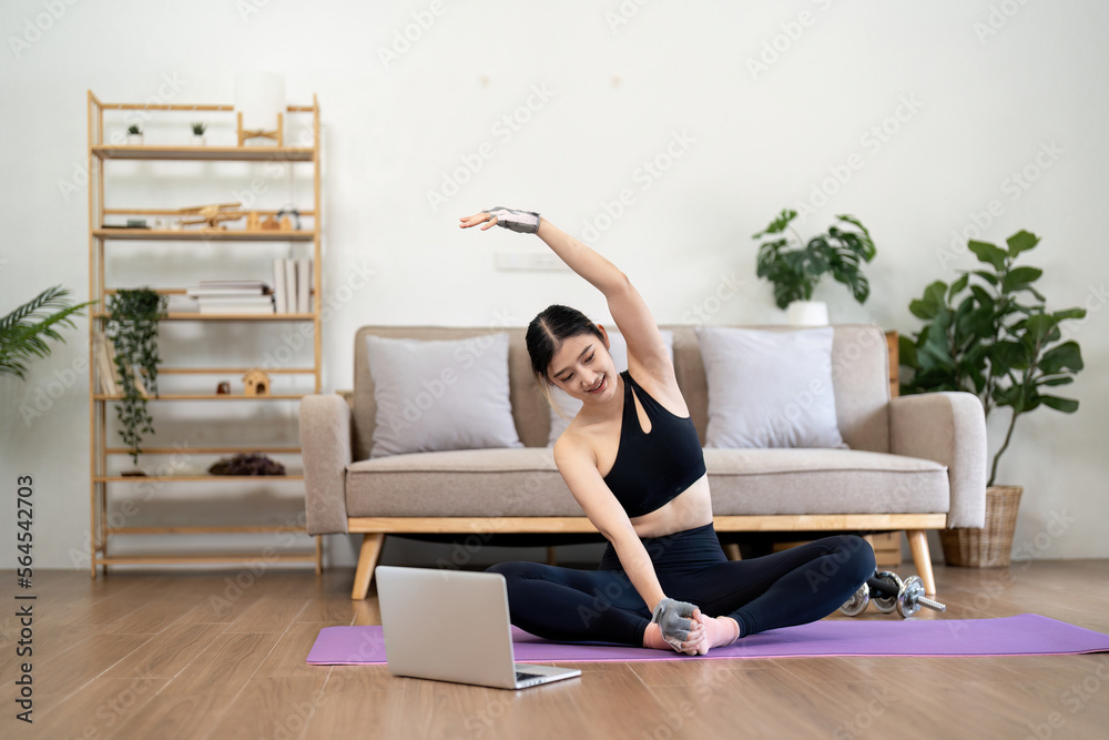 Fit asian woman training fitness exercise sport workout online class on laptop computer at home Fit asian woman training fitness exercise sport workout online class on laptop computer at home