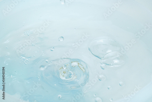 a drops and splashes of water pours into a container of water. 