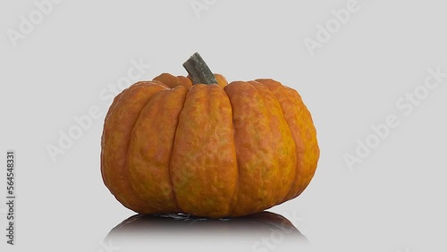 Rotating orange pumpkin isolated on white background