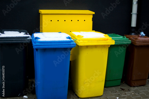 Colorful plastic bins for different waste types.