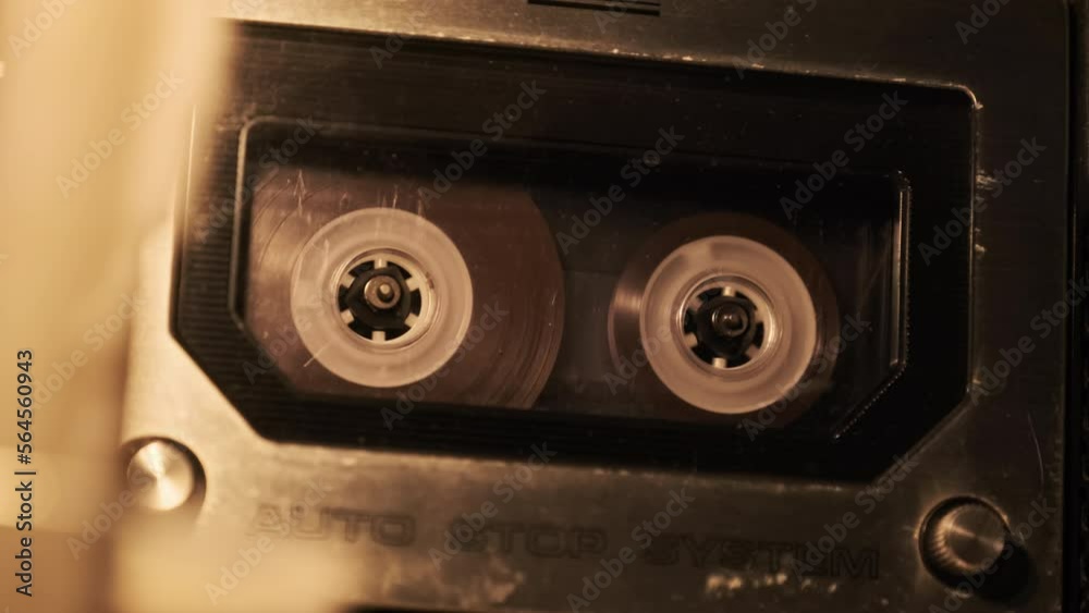 Audio cassette playback in a vintage tape recorder. Record player