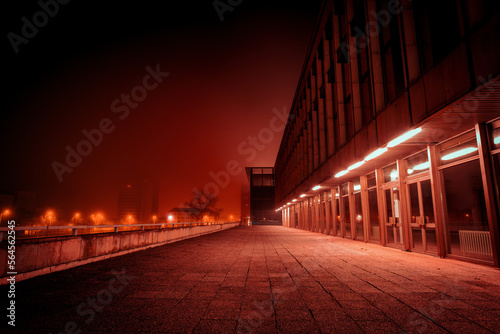 cityscape on a foggy night with red lighting