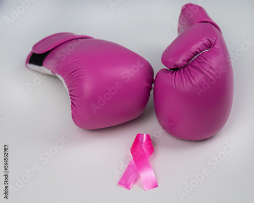 Pink boxing gloves and a pink silk ribbon on a white background. Breast cancer concept.  © Михаил Решетников