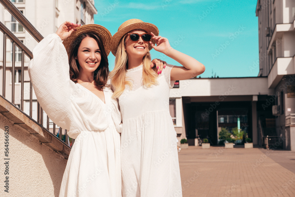 Free Photo  Two young beautiful smiling hipster girls in trendy summer  clothes and panama hat.