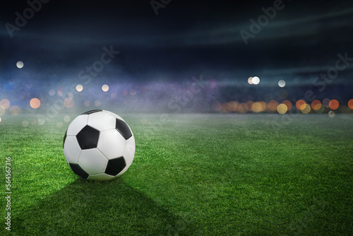 Soccer ball lies on stadium grass in the smoke with copy space, 3D Illustration © Igor Link